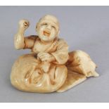 A SMALL JAPANESE MEIJI PERIOD IVORY OKIMONO OF A SEATED MASK MAKER, 1.5in wide & 1in high.