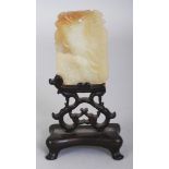 AN EARLY 20TH CENTURY CHINESE CELADON JADE SHAPED RECTANGULAR PENDANT, together with a fitted wood