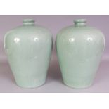 A LARGE PAIR OF CHINESE CELADON MEIPING PORCELAIN VASES, each carved beneath the glaze with a band