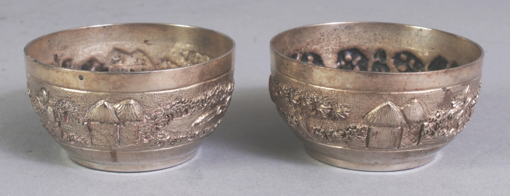 A PAIR OF EARLY/MID 20TH CENTURY INDIAN SILVER-METAL SALTS, weighing approx. 52gm, the sides of each