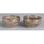 A PAIR OF EARLY/MID 20TH CENTURY INDIAN SILVER-METAL SALTS, weighing approx. 52gm, the sides of each