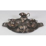 A GROUP OF ORIENTAL MINIATURE SILVER-METAL TEA WARES, comprising a tray, a milk jug, a sugar basin