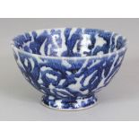 AN UNUSUAL CHINESE BLUE & WHITE PORCELAIN BOWL, painted with a stylised wave design, a few small