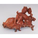 A 20TH CHINESE GOLDSTONE MODEL OF A RECLINING LADY, together with a fitted wood stand, the lady