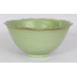 A CHINESE LIME GREEN GLAZED PORCELAIN BOWL, with a shaped and indented octagonal rim, the base