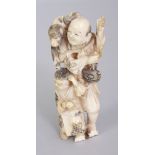 A JAPANESE MEIJI PERIOD IVORY OKIMONO OF A MONKEY ENTERTAINER, in the company of his son, a monkey