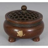 A CHINESE GOLD SPLASH BRONZE TRIPOD CENSER & COVER, the cover pierced with a trellis design, the