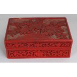 A 20TH CENTURY CHINESE RED CINNABAR RECTANGULAR LACQUER BOX & COVER, the cover carved with peony and