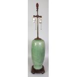 A LARGE CHINESE MING STYLE LONGQUAN CELADON VASE, fitted for electricity on a carved hardwood stand,