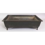 A JAPANESE MEIJI PERIOD RECTANGULAR BRONZE JARDINIERE, the sides decorated in archaic style with
