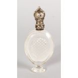 A CUT CRYSTAL FRENCH SCENT BOTTLE with silver top. 3.5ins long.