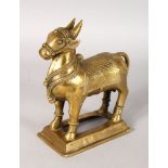 AN ETCHED INDIAN BRASS BULL. 7ins long.