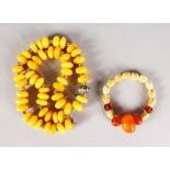 AN AMBER AND SILVER NECKLACE and a small amber and ivory bracelet.