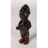 A TRIBAL FERTILITY FIGURE WITH BONE EYES. 6.5ins long.