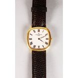 A GOOD 18K YELLOW GOLD BAUME AND MERCIER WRISTWATCH with leather strap.