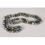 A STRING OF TAHITIAN BAROQUE BLACK PEARLS, 19ins long.