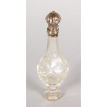 A CUT CRYSTAL FRENCH SCENT BOTTLE with silver top. 4ins long.