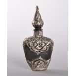 A SMALL INDIAN EBONY AND SILVER MOUNTED SCENT BOTTLE. 6.5cms.