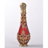 A LOUIS XVI STYLE RED GLASS SCENT BOTTLE AND STOPPER in a pierced and engraved silver gilt case,
