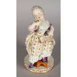 A GOOD MEISSEN FIGURE OF A YOUNG GIRL LOOKING AT HER WATCH. Cross swords mark in blue. Incised