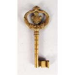 A GERMAN CAST BRASS KEY with crest. 8.5ins long.
