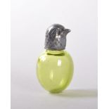 A VICTORIAN GREEN GLASS PERFUME BOTTLE, with silver screw cap in the shape of a bird. 4cms.