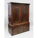 AN 18TH CENTURY OAK HANGING CUPBOARD, the upper section with two panel doors, with three panels