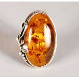 A SILVER AND AMBER RING.