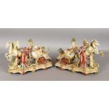 A PAIR OF AUSTRIAN PORCELAIN CHARIOT GROUPS with two horses and attendant. 11ins long.