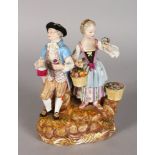 A GOOD 19TH CENTURY MEISSEN FIGURE GROUP OF A YOUNG MAN AND LADY, the man carrying a bottle and
