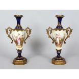 A GOOD SMALL PAIR OF SEVRES ORMOLU MOUNTED TWO HANDLED VASES/URNS, painted with a classical young