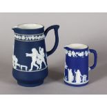 A WEDGWOOD BLUE AND WHITE JASPER WARE JUG, cupids playing Blind Man's Bluff, 6.5ins high, and A