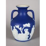 A SMALL WEDGWOOD VERSION OF THE PORTLAND VASE, blue and white jasper ware. Impressed WEDGWOOD