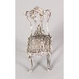 A SILVER NOVELTY CHAIR.