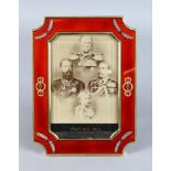 A SUPERB "FABERGE" RED ENAMEL AND SILVER GILT PHOTOGRAPH FRAME, set with precious stones. 8ins high,