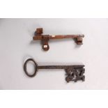 A 17TH CENTURY POLISHED STEEL DOUBLE ENDED KEY, 5.25ins, and A VERY EARLY IRON KEY, 6.5ins (2).