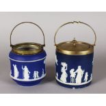 TWO WEDGWOOD BLUE AND WHITE JASPER WARE BISCUIT BARRELS AND COVERS. Impressed WEDGWOOD. 5ins high.