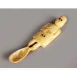 A SMALL SCOTTISH CARVED BONE SPOON, carved as a Scottish man. 3.5ins long.