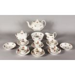 AN ENGLISH TEA SET, sprigged with pink roses, comprising teapot, sucrier, milk jug, six cups and