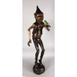 AN AMUSING BRONZE FIGURE GROUP, depicting a standing pixie with a frog on his hand. 3ft 3ins high.
