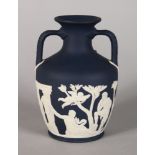 A SMALLER WEDGWOOD VERSION OF THE PORTLAND VASE, dark blue and white. Impressed WEDGWOOD. 5.75ins