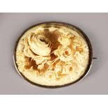 A VICTORIAN CARVED IVORY FLORAL OVAL BROOCH.