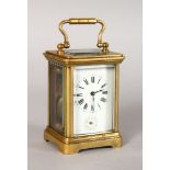 A MINIATURE BRASS ALARM CARRIAGE CLOCK, white porcelain dial, black enamel numerals and hands, in