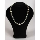 A VERY GOOD SET OF THIRTY-FIVE BLACK PEARLS with diamond clasp.