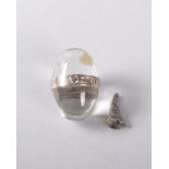 A MINIATURE EGG SHAPED CLEAR CRYSTAL SILVER MOUNTED PERFUME BOTTLE. 2.5cms. Provenance: CHELSEA