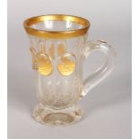 A GOOD 19TH CENTURY BOHEMIAN CLEAR GLASS OCTAGONAL SHAPED MUG, gilt decoration and five panels of