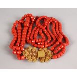 A GOOD THREE ROW CORAL NECKLACE with gold filigree clasp, 232gms.