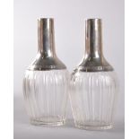 A PAIR OF SILVER MOUNTED DECANTERS.