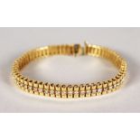 A VERY GOOD 18CT YELLOW GOLD DIAMOND SET LINE BRACELET.