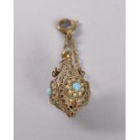 A MINIATURE FRENCH SILVER GILT PERFUME BOTTLE decorated with turquoise, silver gilt ring and